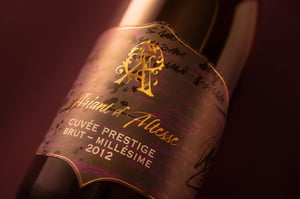 Close-up of a champagne bottle label with gold foil lettering