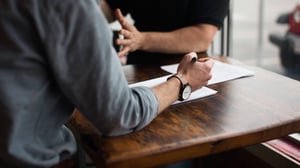 Two people discussing product traceability requirements